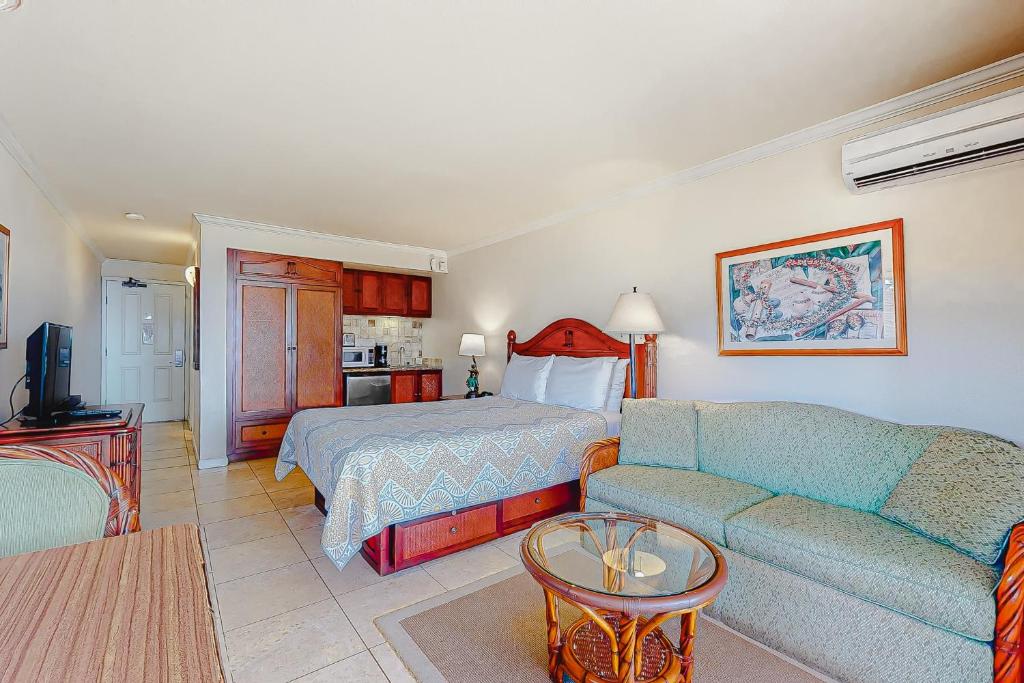a hotel room with a bed and a couch at Islander on the Beach 304 in Kapaa