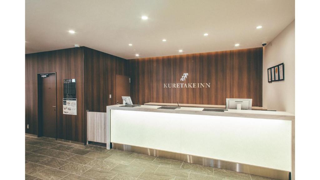 a lobby with a reception desk in a building at Kuretake Inn Premium Shizuoka Annex in Shizuoka