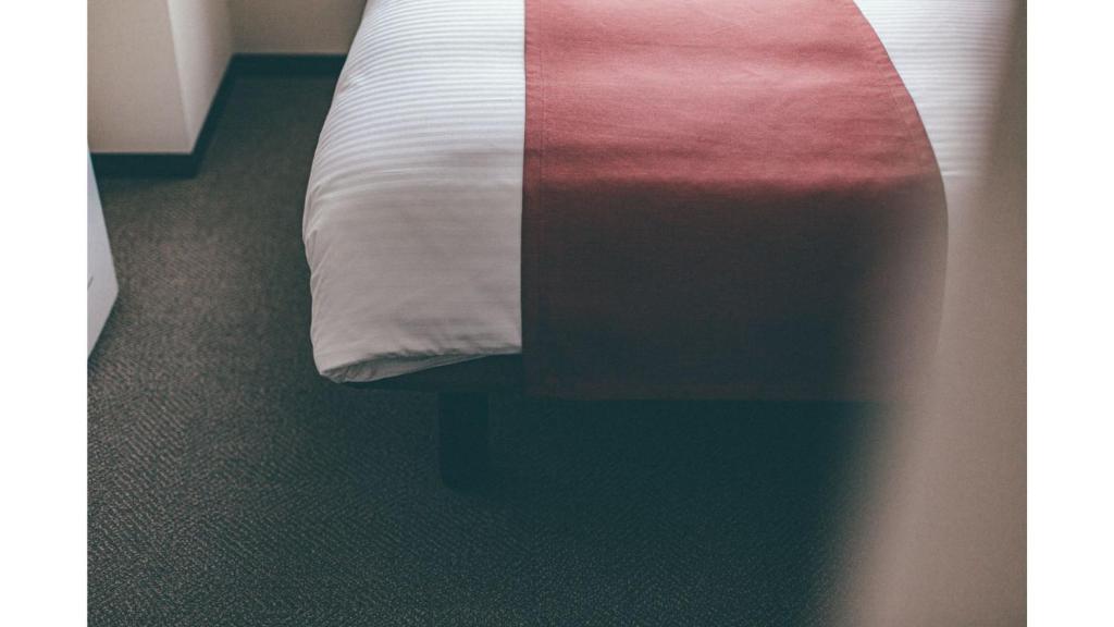 Postel nebo postele na pokoji v ubytování Kuretake Inn Premium Shizuoka Annex
