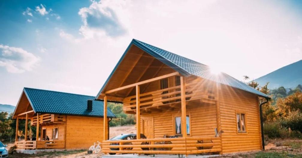 a log cabin with a solar roof at Cottage on the Rama lake in Jaklići