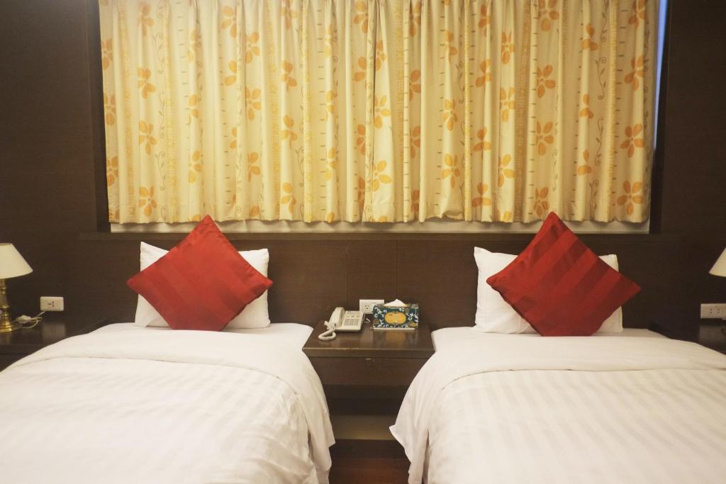 Postel nebo postele na pokoji v ubytování Fu Chang Hotel