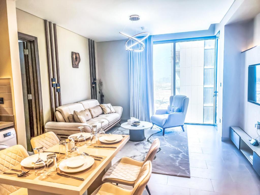 a living room with a table and chairs at STAY BY LATINEM Luxury 2BR Holiday Home CV A1409 near Burj Khalifa in Dubai