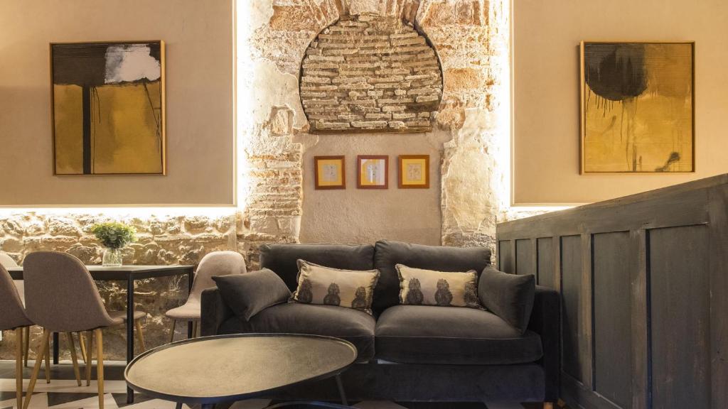 a living room with a couch and a table at Virgen Blanca - Apartamentos Aloha Toledo in Toledo