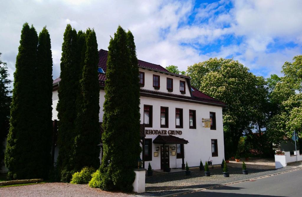 a white building with trees in front of it at Rhodaer Grund in Erfurt