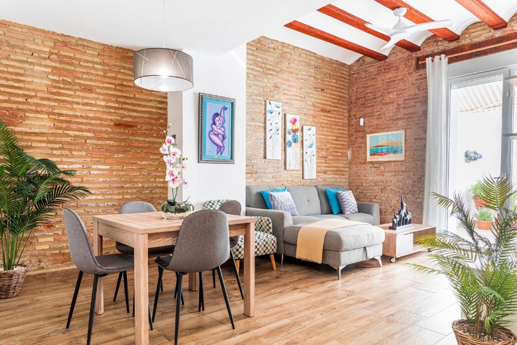a living room with a table and chairs and a couch at Flats Piera Valencia Center in Valencia
