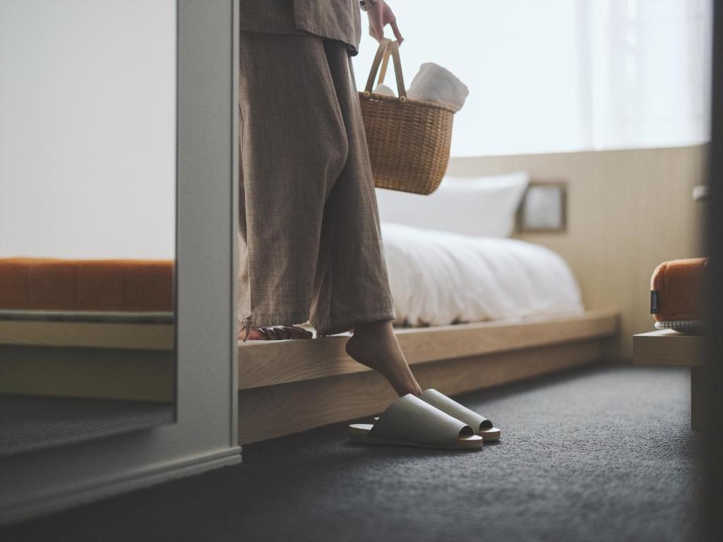 Postel nebo postele na pokoji v ubytování SOKI Kanazawa