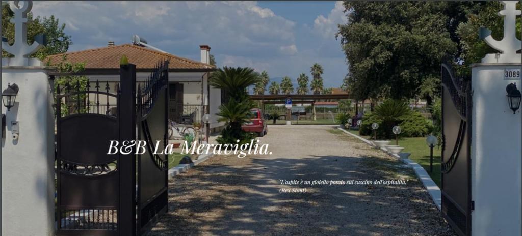 a gate to a house with a driveway at B&B LA MERAVIGLIA in Borgo Grappa