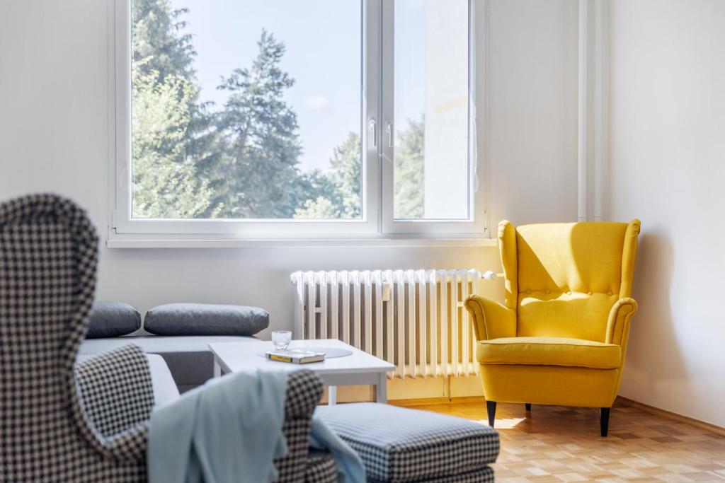 sala de estar con sofá y silla en Apartman JakoDoma en Česká Lípa