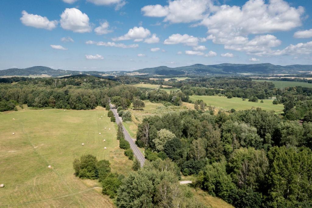 an aerial view of a field with trees and cows at Apartman JakoDoma vlastní parkování u domu ZDARMA in Česká Lípa