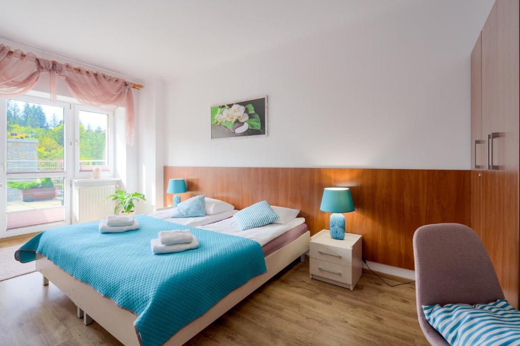 Postel nebo postele na pokoji v ubytování Apartament z tarasem 204