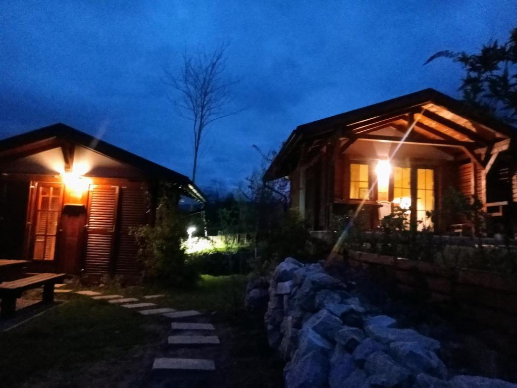 a log cabin at night with lights on at NIKOLIJA 3 in Bajina Bašta