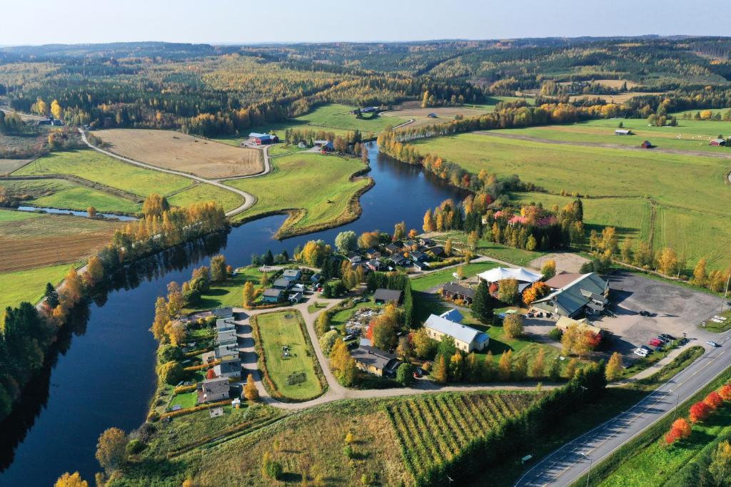 an aerial view of a village next to a river at Kartano Kievari in Äänekoski