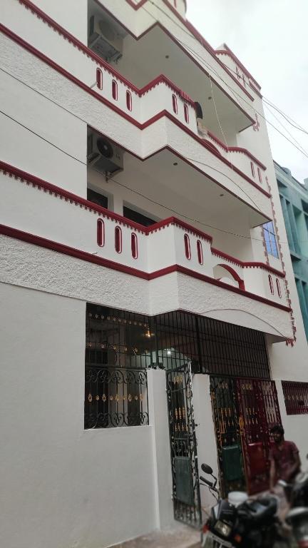 a white building with a gate in front of it at Villa Souhayl homestay in Pondicherry