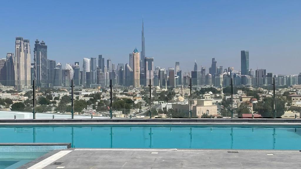 a swimming pool with a view of a city at Al Khoory Courtyard Hotel in Dubai