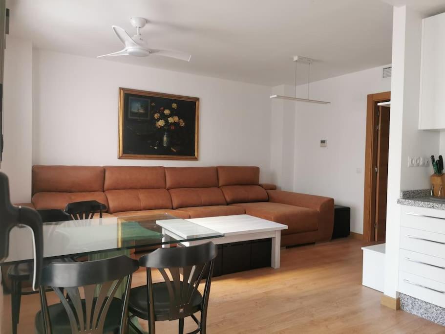 a living room with a couch and a table at APART-DUPLEX-ATICO Tomares in Tomares