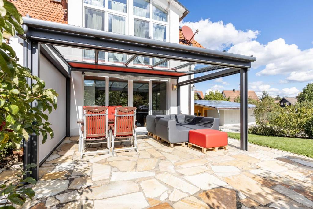 an extension of a house with glass doors and a patio at Villa Grafrath in Grafrath