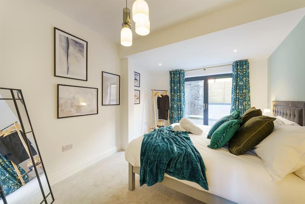 a bedroom with a bed with pillows and a window at Bressingham - 2 Bedroom Luxury Apartment by Mint Stays in Bristol