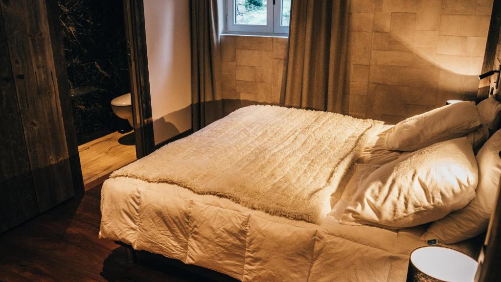a bed in a room with a window at Chalet Camillou in Champagny-en-Vanoise