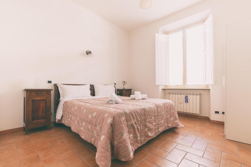 Posteľ alebo postele v izbe v ubytovaní HT Laterano Apartment