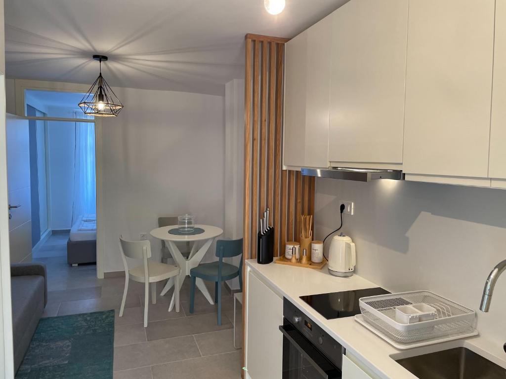 a kitchen with a table and a dining room at Barbi Blue Apartments in Herceg-Novi