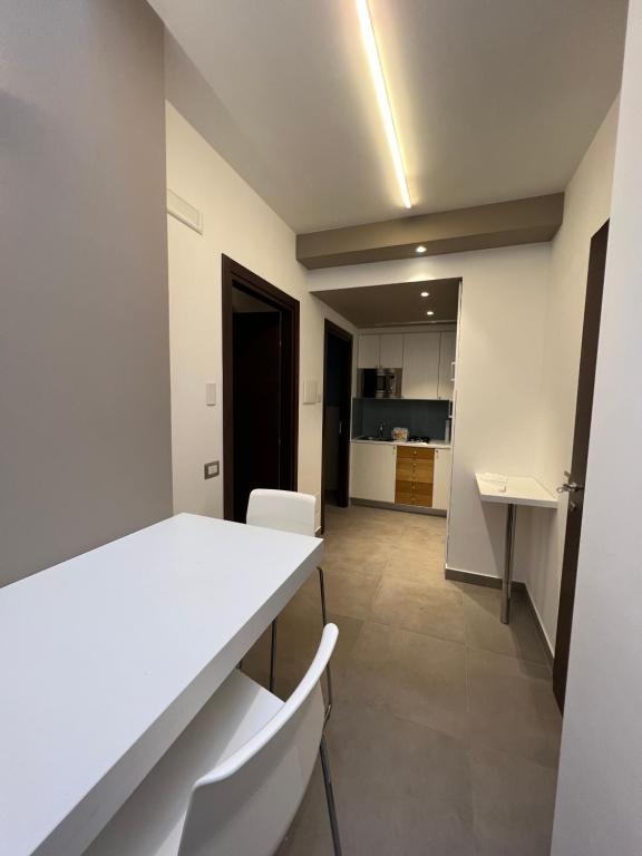 an empty room with a white table and chairs at Villa Russo Apartment in Trecastagni
