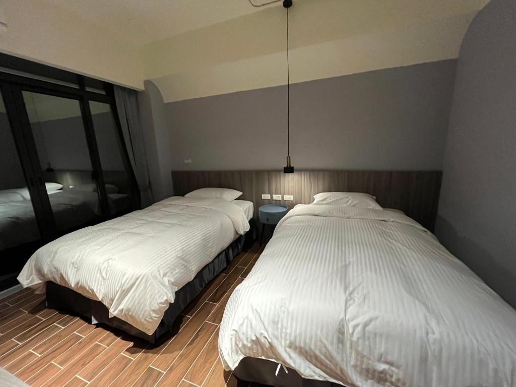 Postel nebo postele na pokoji v ubytování 飛鳥集行館