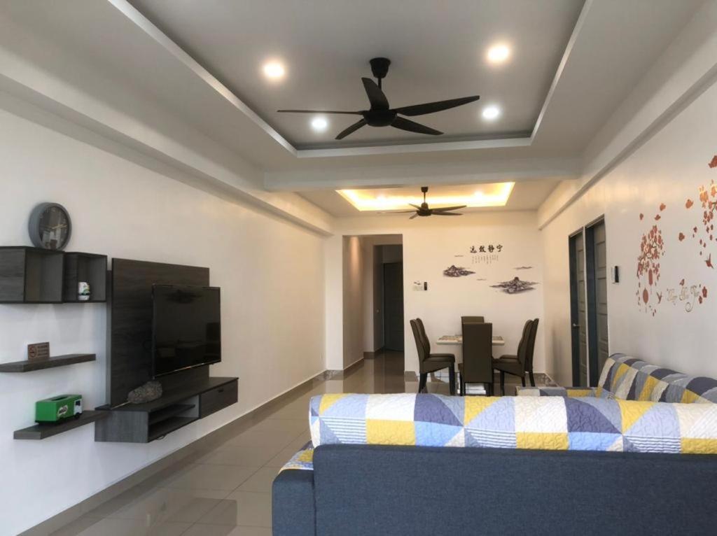 a living room with a couch and a ceiling fan at Venus Hollywood Homestay Sitiawan in Seri Manjung