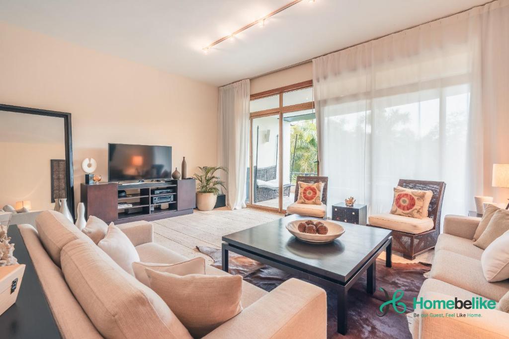 a living room with a couch and a table at Be relaxed at this 2BR apt at Casa De Campo in Buena Vista