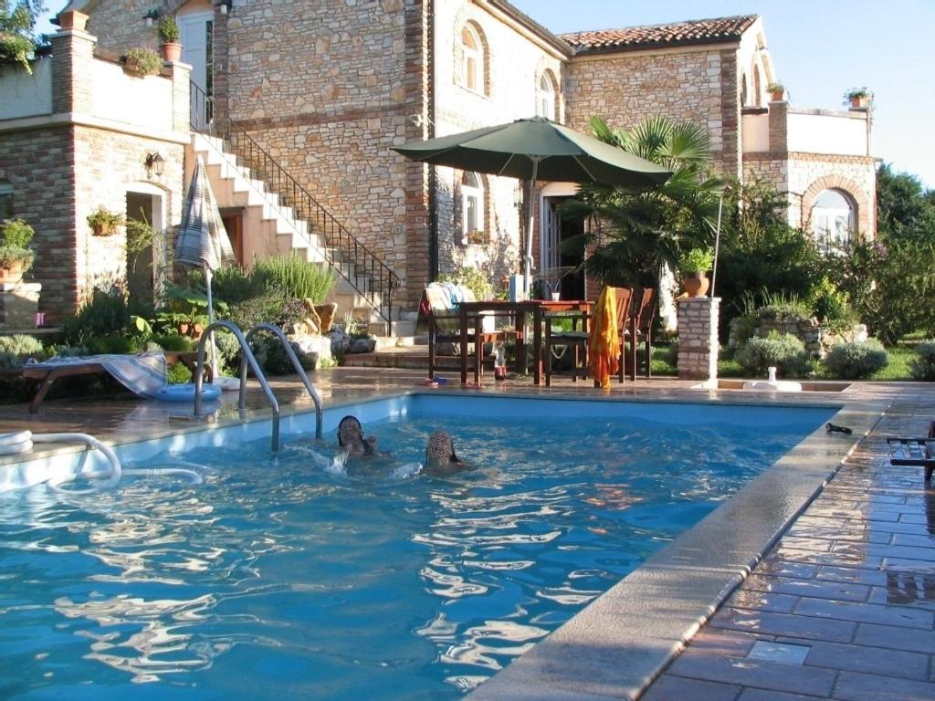 a woman in a swimming pool in a house at Villa in Funtana with private Tenniscourt (3418) in Funtana