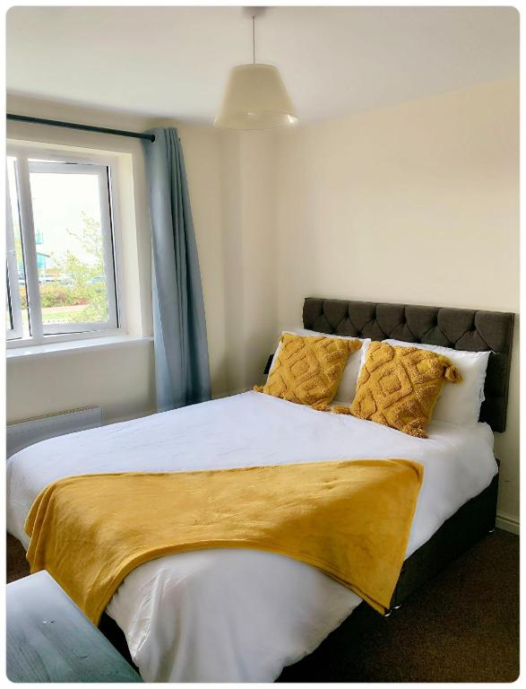 a bedroom with a large bed with a window at DARTFORD CROSSING The BRIDGE PLACE - CONTRACTORS FAVOURITE in Kent