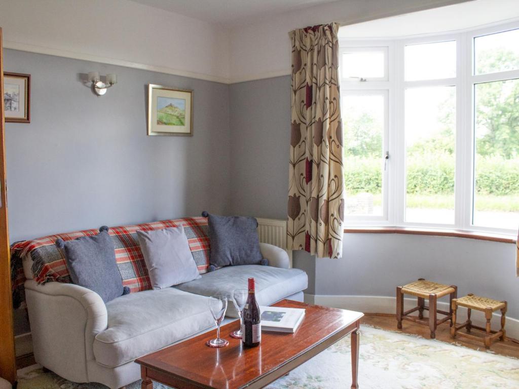 a living room with a couch and a table at Spacious family home close to Llandeilo in Llandeilo