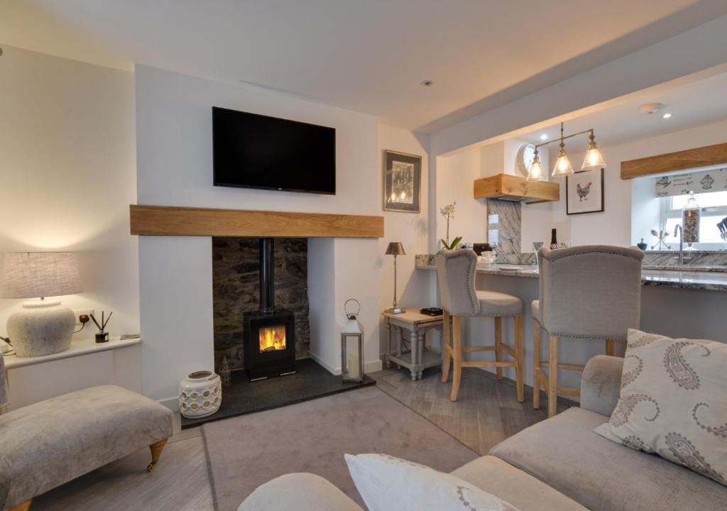 a living room with a fireplace and a living room with at Naw Stryd y Capel in Conwy