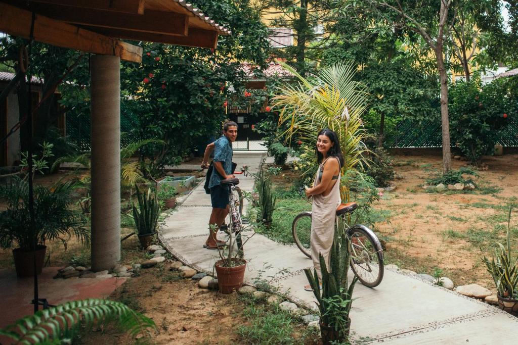 a man on a bike with a woman on a bike at Casona Puerto Dreams in Puerto Escondido