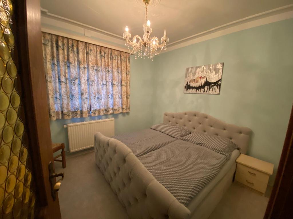 a bedroom with a bed and a chandelier at Apartment Feistriz in Rosental 9181 in Feistritz im Rosental