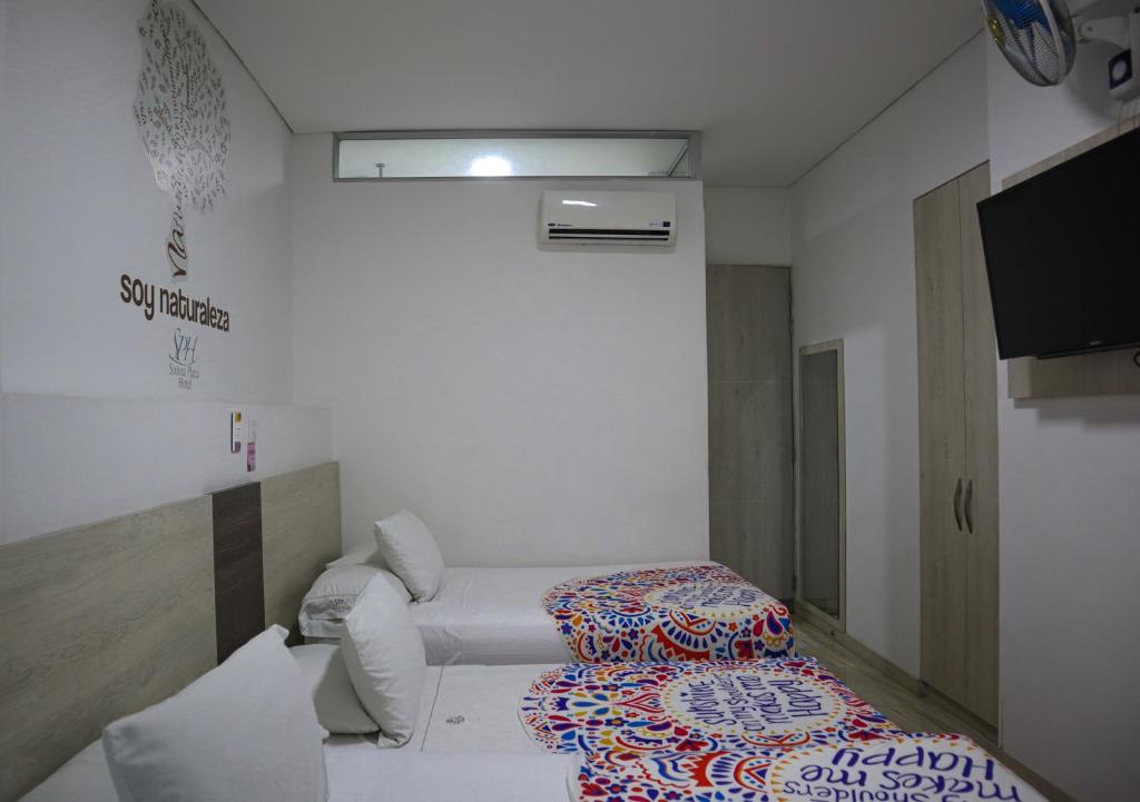 Postel nebo postele na pokoji v ubytování Hotel Sixtina Plaza Medellin