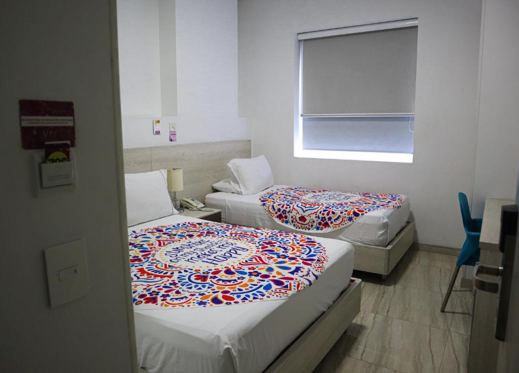 Postel nebo postele na pokoji v ubytování Hotel Sixtina Plaza Medellin