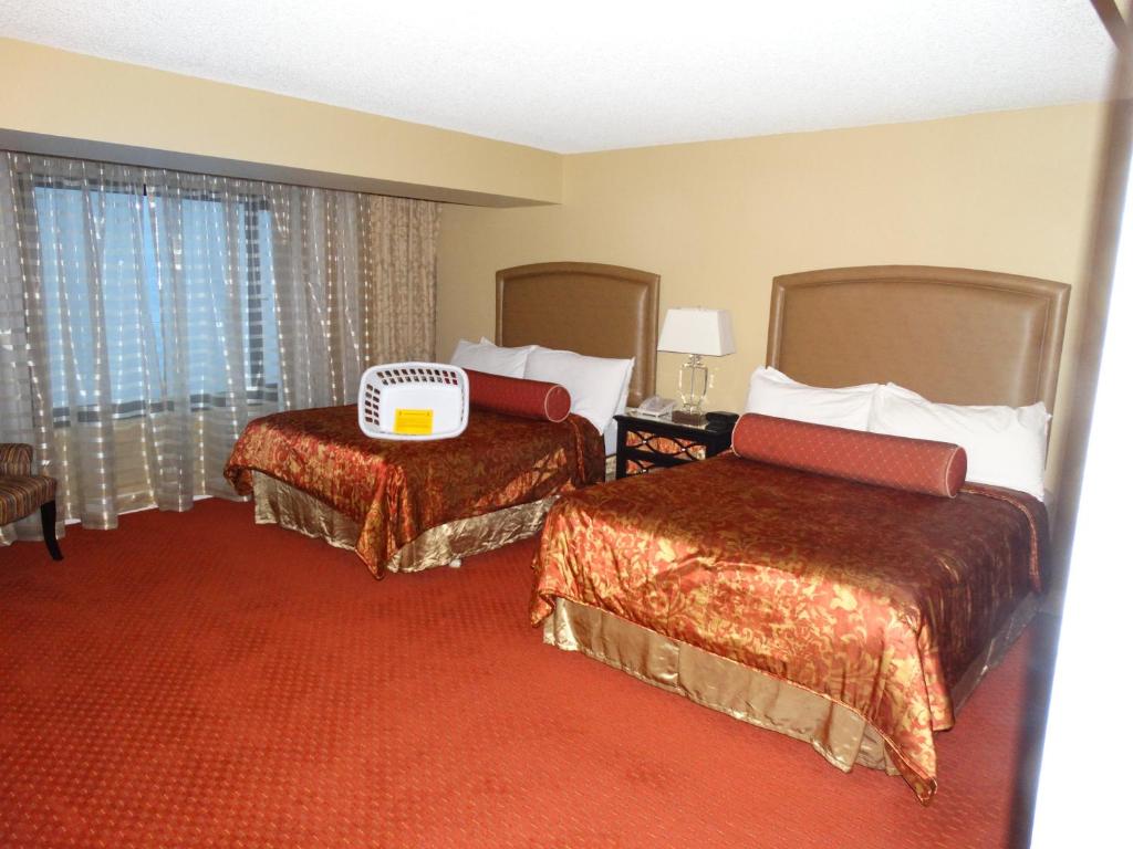 a hotel room with two beds and a window at Suites at Jockey Club (No Resort Fee) in Las Vegas