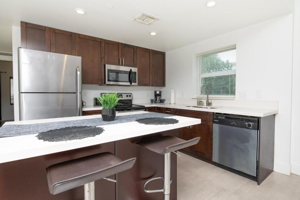 a kitchen with wooden cabinets and a stainless steel refrigerator at Spacious entire Apartment with Free Parking in Hollywood