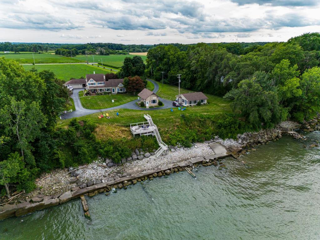 an aerial view of a house on an island in the water at Cozy Lakefront Cottage in Huron