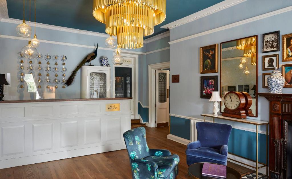 a living room with two chairs and a chandelier at Hotel Indigo - Bath by IHG in Bath