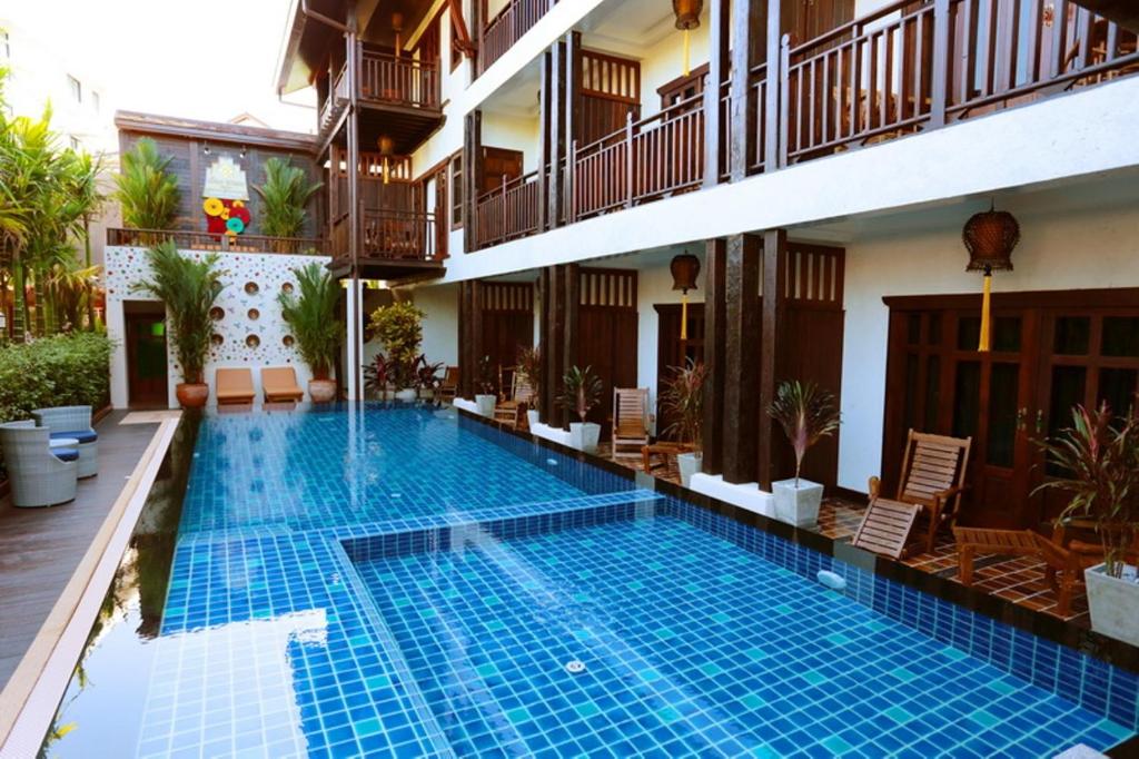 a swimming pool in the middle of a building at Viang Thapae Resort- SHA Extra Plus in Chiang Mai