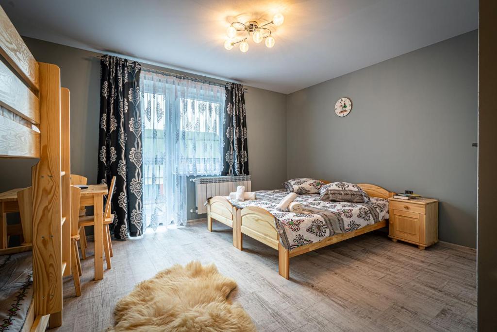 a bedroom with a bed and a dog laying on the floor at Villa Balos in Gronków