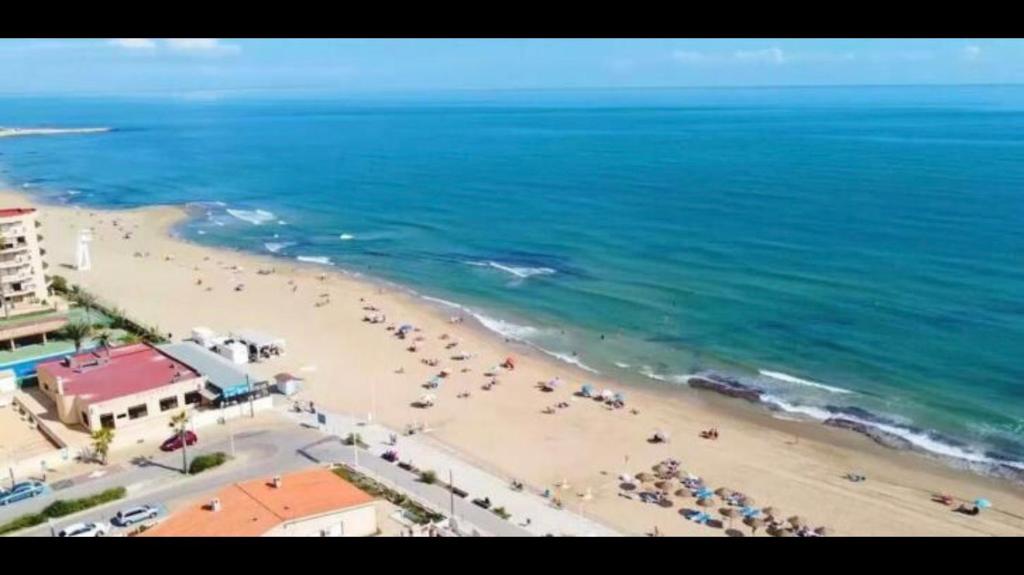 widok na plażę z grupą ludzi w obiekcie Espacioso Estudio cerca de la playa La Mata w mieście La Mata