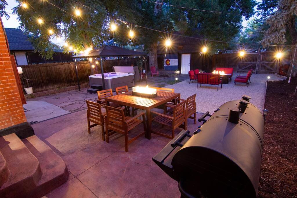 a backyard with a grill and a table with lights at Perfect Urban Sanctuary for 8 w Hot Tub near City Park in Denver