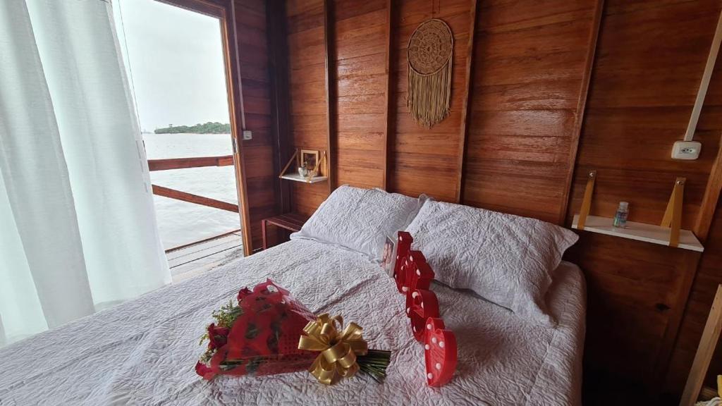 a bed with a christmas decoration on top of it at Casa Flutuante - Experiência única in Manaus