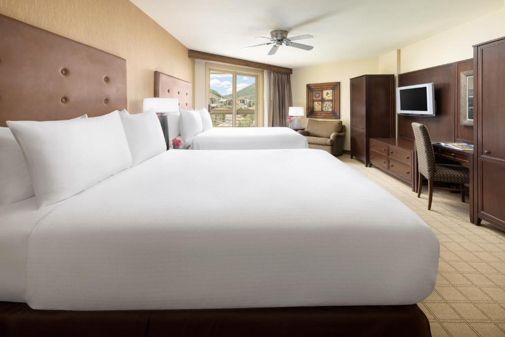 a large white bed in a hotel room at Elevation Hotel & Spa in Crested Butte
