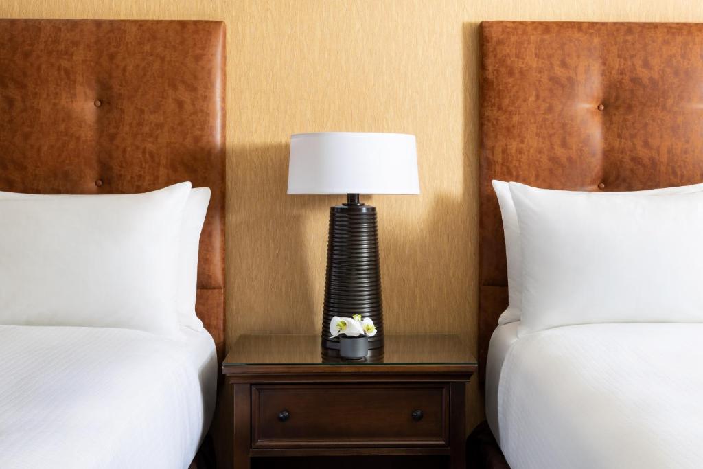 a lamp sitting on a table between two beds at Elevation Hotel & Spa in Crested Butte