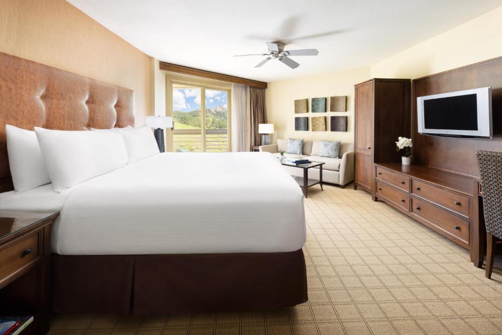 a large bedroom with a large bed and a television at Elevation Hotel & Spa in Crested Butte