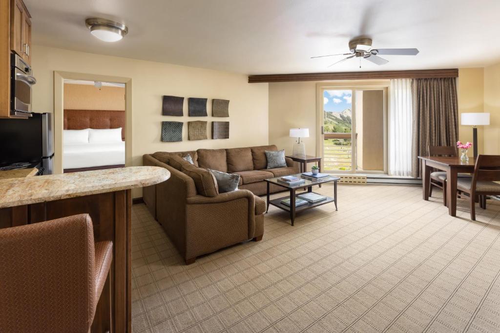 a living room with a couch and a bed at Elevation Hotel & Spa in Crested Butte