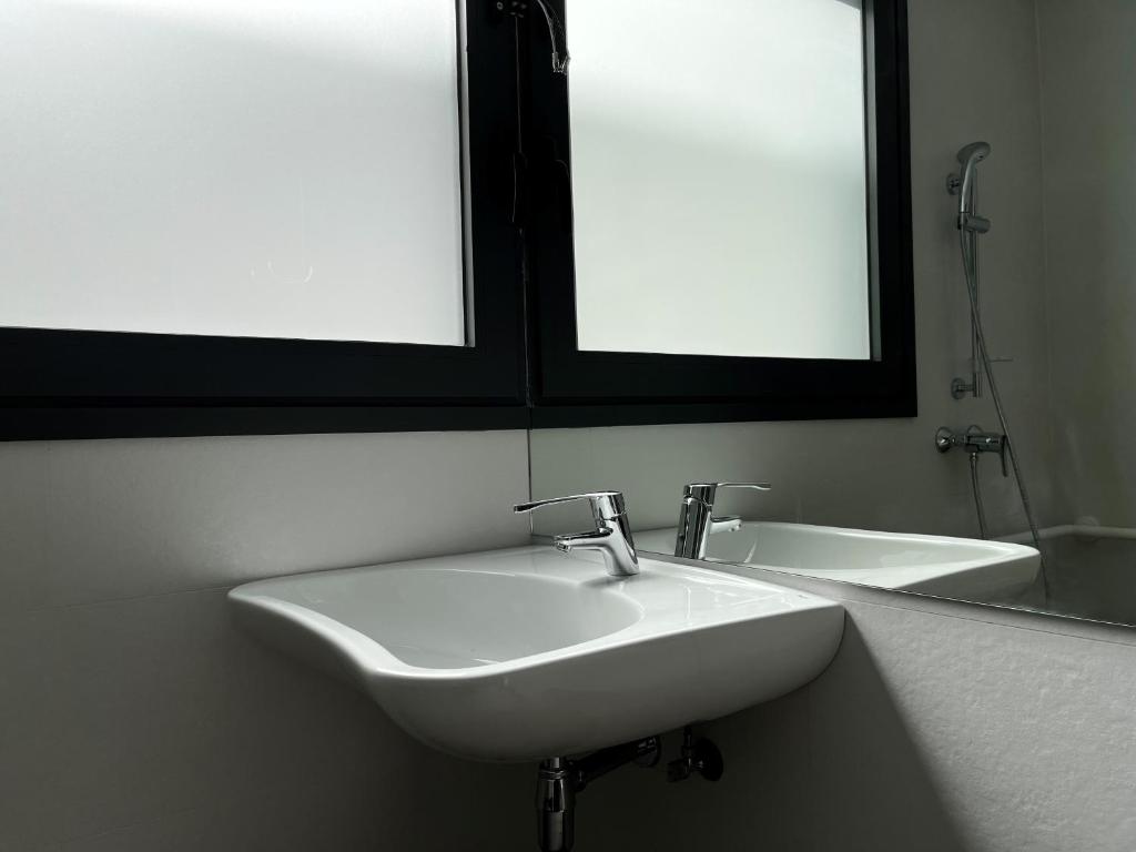 a bathroom with a white sink and a mirror at Hs Madrid Centro Atocha in Madrid